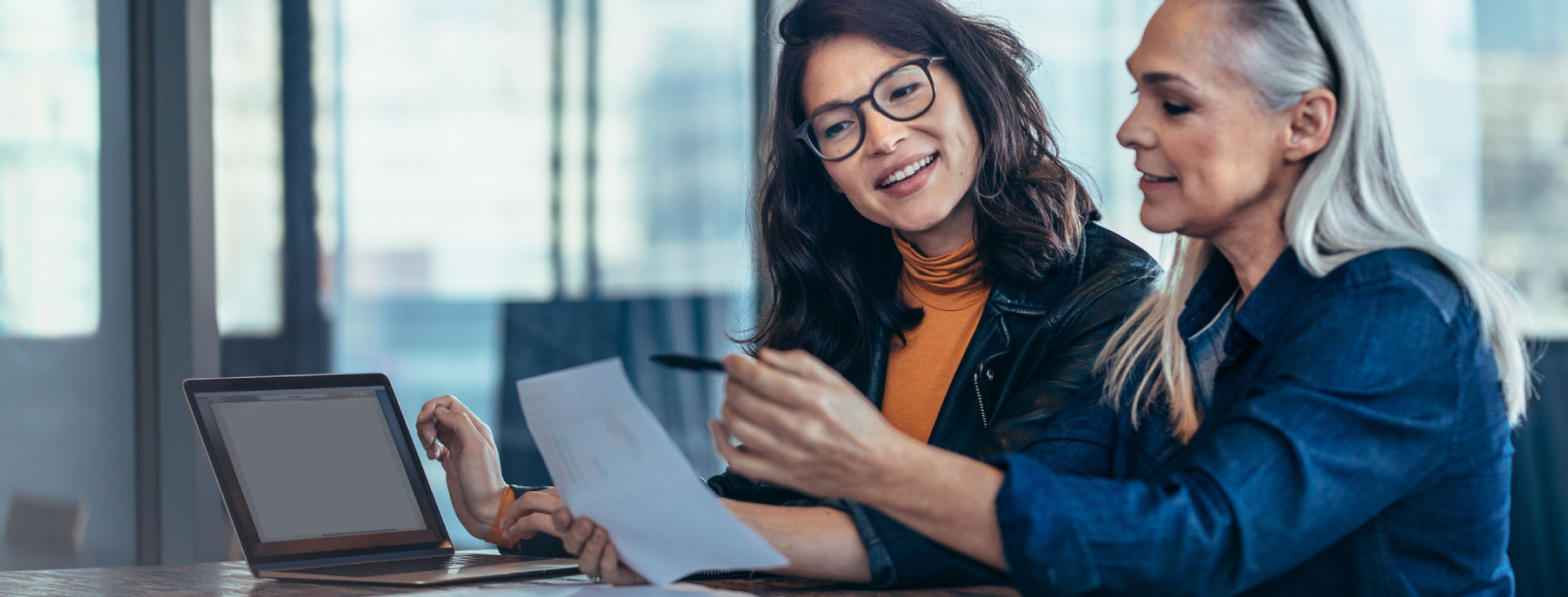 Two businesswomen looking at a document