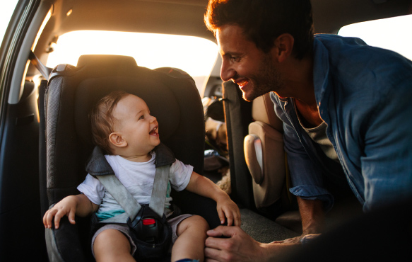 Man securing baby in carseat